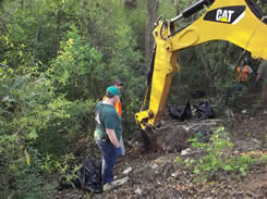 Equipment with scoop picking up trash