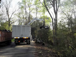 Truck with grab arm at clean up